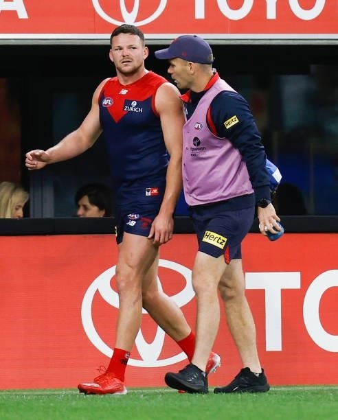 Steven May of the Demons leaves the ground with an injury during the 2021 AFL First Preliminary Final match between the Melbourne Demons and the...