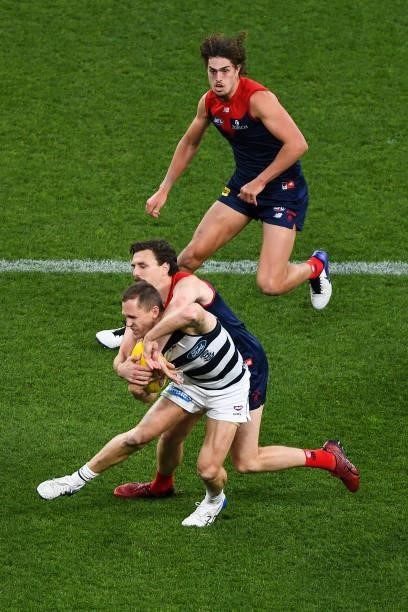 Joel Selwood of the Cats is tackled by Jake Lever of the Demons during the 2021 AFL First Preliminary Final match between the Melbourne Demons and...