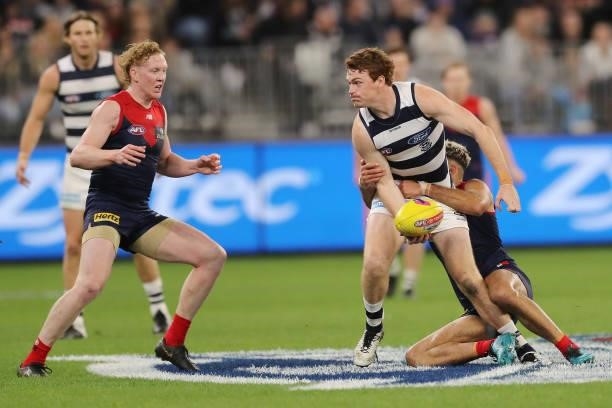 Gary Rohan of the Cats looks to pass the ball under pressure from Christian Salem of the Demons during the 2021 AFL First Preliminary Final match...
