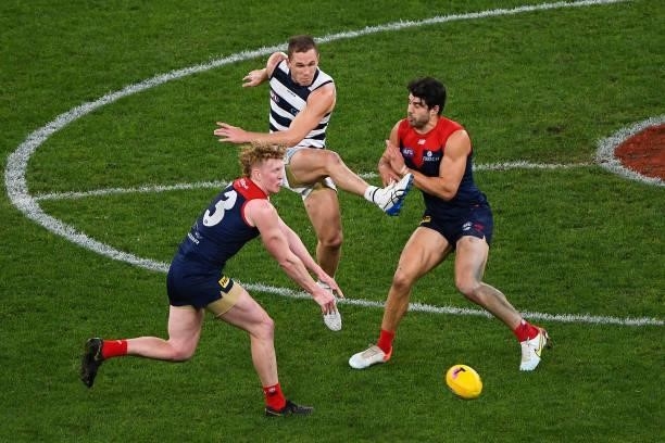 Joel Selwood of the Cats has his kick spoilt be Christian Petracca of the Demons during the 2021 AFL First Preliminary Final match between the...