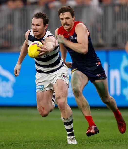 Patrick Dangerfield of the Cats is chased by Jake Lever of the Demons during the 2021 AFL First Preliminary Final match between the Melbourne Demons...
