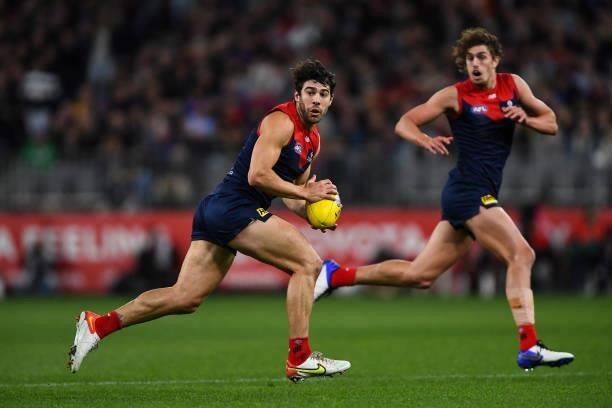 Christian Petracca of the Demons runs with the ball during the 2021 AFL First Preliminary Final match between the Melbourne Demons and the Geelong...
