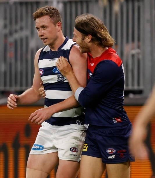 Ed Langdon of the Demons and Mitch Duncan of the Cats exchange words during the 2021 AFL First Preliminary Final match between the Melbourne Demons...