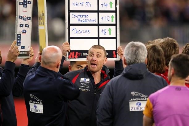 Simon Goodwin, Senior Coach of the Demons coach addresses the team at three quarter time break during the 2021 AFL First Preliminary Final match...