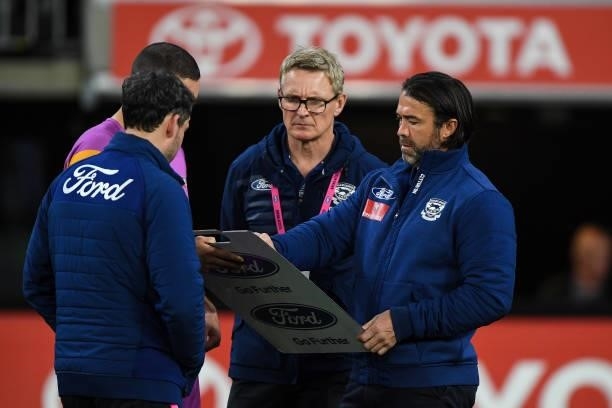 Chris Scott, Senior Coach of the Cats looks at the team board at three quarter time during the 2021 AFL First Preliminary Final match between the...