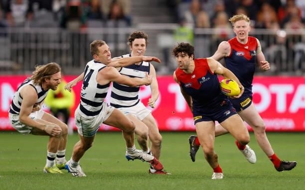 Christian Petracca of the Demons and Joel Selwood of the Catsin action during the 2021 AFL First Preliminary Final match between the Melbourne Demons...