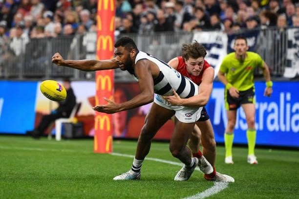Esava Ratugolea of the Cats is tackled by Tom Sparrow of the Demons during the 2021 AFL First Preliminary Final match between the Melbourne Demons...