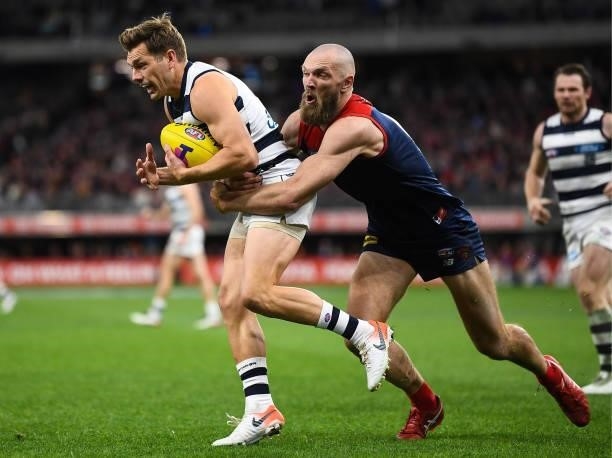 Shaun Higgins of the Cats is tackled by Max Gawn during the 2021 AFL First Preliminary Final match between the Melbourne Demons and the Geelong Cats...