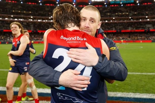 Trent Rivers and Simon Goodwin, Senior Coach of the Demons celebrate during the 2021 AFL First Preliminary Final match between the Melbourne Demons...