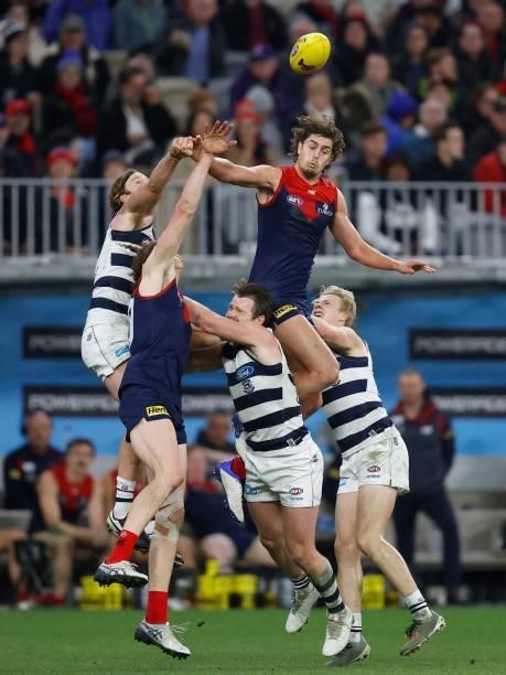 Luke Jackson of the Demons punches the ball over Patrick Dangerfield of the Cats during the 2021 AFL First Preliminary Final match between the...