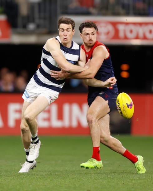 Jeremy Cameron of the Cats and Michael Hibberd of the Demons in action during the 2021 AFL First Preliminary Final match between the Melbourne Demons...