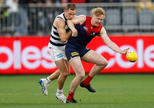 Clayton Oliver of the Demons and Joel Selwood of the Cats in action during the 2021 AFL First Preliminary Final match between the Melbourne Demons...