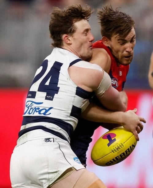Jack Viney of the Demons is tackled by Jed Bews of the Cats during the 2021 AFL First Preliminary Final match between the Melbourne Demons and the...