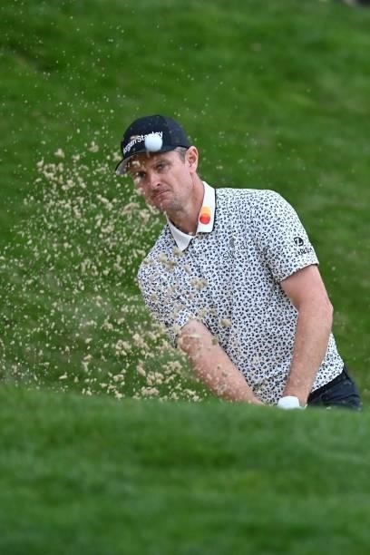 England's Justin Rose plays out of the bunker on the 18th on Day 2 of the PGA Championship at Wentworth Golf Club in Surrey, south west of London on...