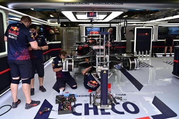 Mechanics work on the car of Red Bull's Mexican driver Sergio Perez prior to a qualifying session at the Autodromo Nazionale circuit in Monza, on...