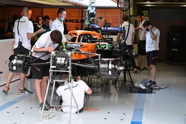 Mechanics work on the car of McLaren's British driver Lando Norris prior to a qualifying session at the Autodromo Nazionale circuit in Monza, on...