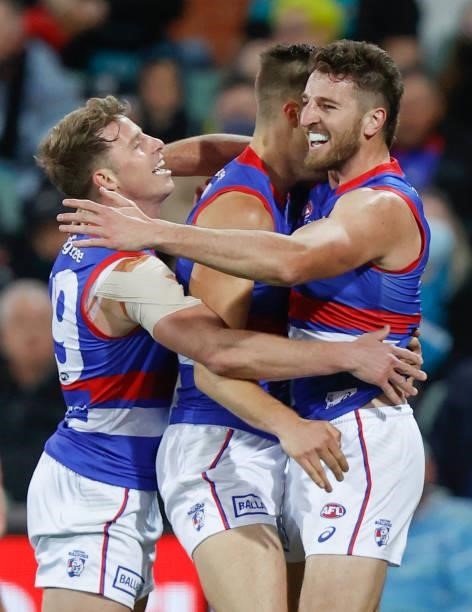 Mitch Hannan, Josh Schache and Marcus Bontempelli of the Bulldogs celebrate during the 2021 AFL Second Preliminary Final match between the Port...