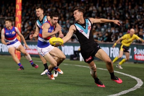 Easton Wood of the Bulldogs attempts to tackle Connor Rozee of the Power during the 2021 AFL Second Preliminary Final match between the Port Adelaide...