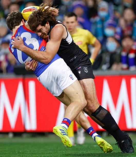 Laitham Vandermeer of the Bulldogs is tackled by Scott Lycett of the Power during the 2021 AFL Second Preliminary Final match between the Port...