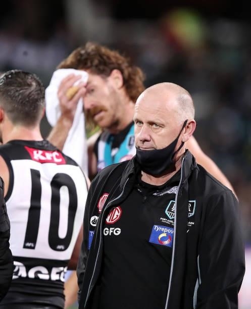 Ken Hinkley, Senior Coach of the Power at quarter time with Scott Lycett in the background during the 2021 AFL Second Preliminary Final match between...