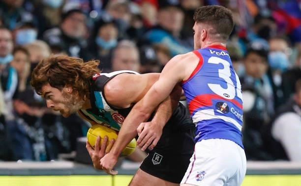 Scott Lycett of the Power is tackled by Bailey Williams of the Bulldogs during the 2021 AFL Second Preliminary Final match between the Port Adelaide...