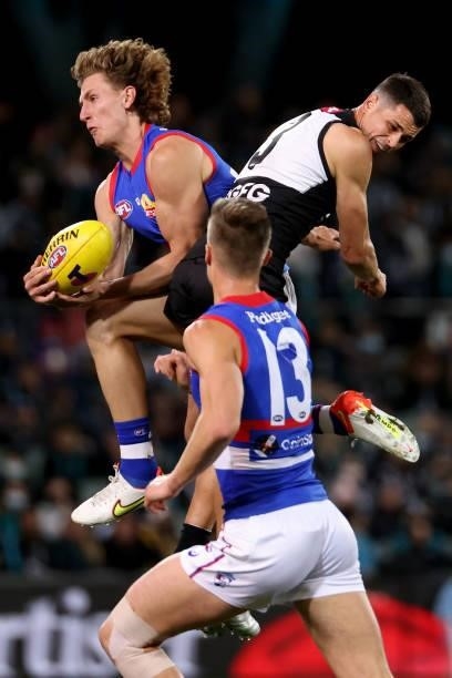 Aaron Naughton of the Bulldogs clashes with Ryan Burton of the Power during the 2021 AFL Second Preliminary Final match between the Port Adelaide...