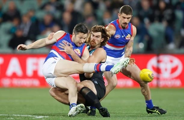 Stefan Martin of the Bulldogs is tackled by Scott Lycett of the Power during the 2021 AFL Second Preliminary Final match between the Port Adelaide...