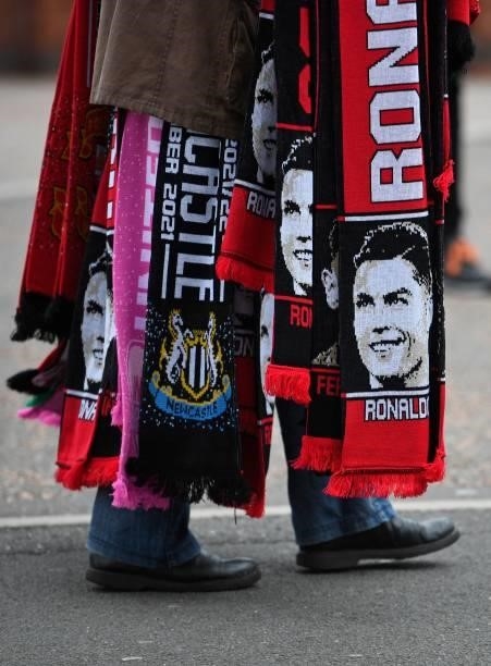 Scarves featuring players including new signing Cristiano Ronaldo are sold ahead of the English Premier League football match between Manchester...
