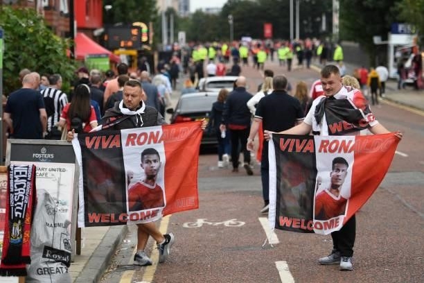 Merchandise sellers display flags with a picture of Cristiano Ronaldo on them outside the ground ahead of the English Premier League football match...