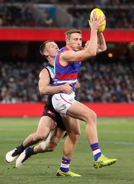 Bailey Dale of the Bulldogs and Robbie Gray of the Power during the 2021 AFL Second Preliminary Final match between the Port Adelaide Power and the...