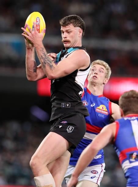 Peter Ladhams of the Power and Tim English compete for the ball during the 2021 AFL Second Preliminary Final match between the Port Adelaide Power...