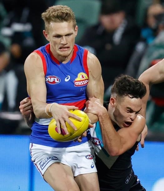 Adam Treloar of the Bulldogs is tackled by Karl Amon of the Power during the 2021 AFL Second Preliminary Final match between the Port Adelaide Power...