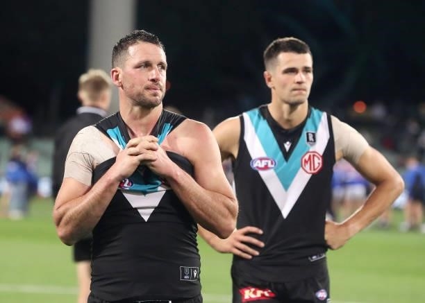 Travis Boak of the Power and Ryan Burton after the loss during the 2021 AFL Second Preliminary Final match between the Port Adelaide Power and the...
