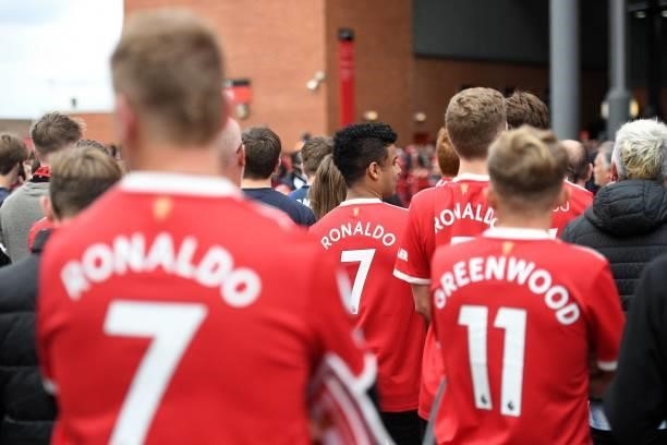 Manchester United fans wearing Cristiano Ronaldo shirts wait for the team coach to arrive outside the ground ahead of the English Premier League...