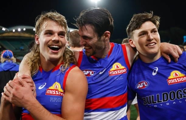 Bailey Smith, Easton Wood and Laitham Vandermeer of the Bulldogs celebrate during the 2021 AFL Second Preliminary Final match between the Port...