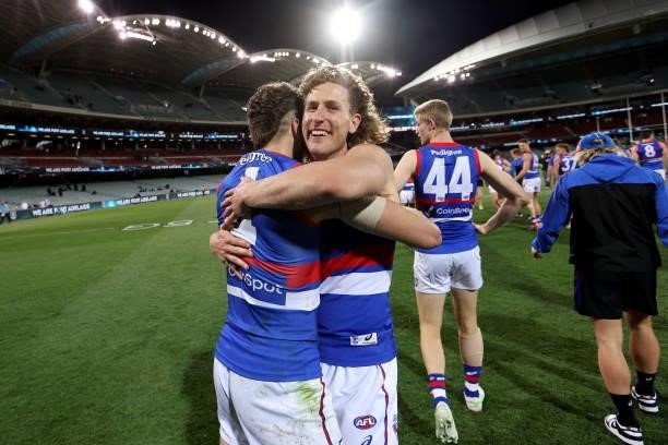 Marcus Bontempelli and Aaron Naughton of the Bulldogs celebrate their win during the 2021 AFL Second Preliminary Final match between the Port...