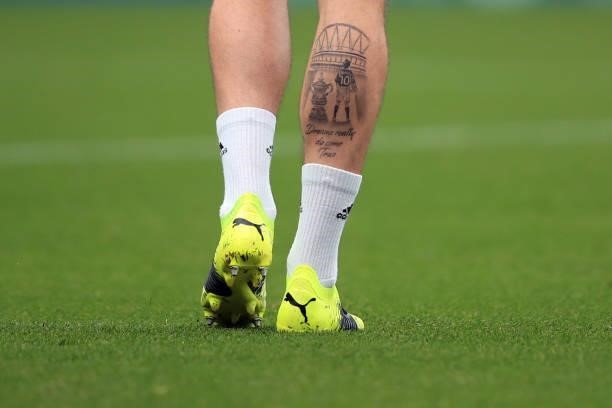 The tattood calf of James Maddison of Leicester City featuring the Wembley Stadium arch, FA cup trophy during the Premier League match between...