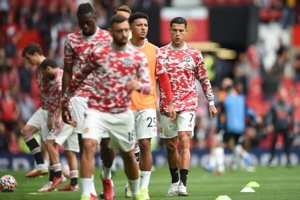 Manchester United's Portuguese striker Cristiano Ronaldo warms up with teammates ahead of the English Premier League football match between...