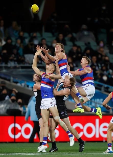 Aaron Naughton of the Bulldogs attempts to mark over Tom Jonas of the Power during the 2021 AFL Second Preliminary Final match between the Port...