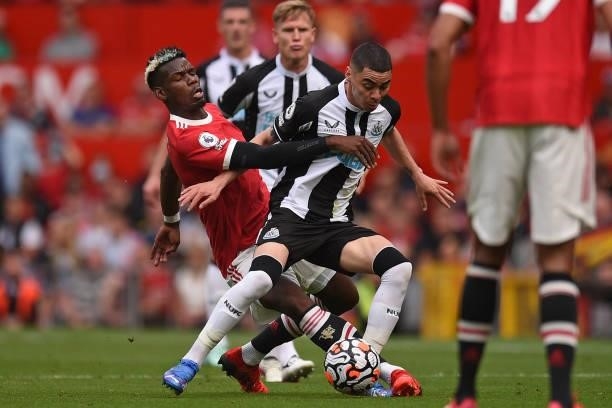 Newcastle United's Paraguayan midfielder Miguel Almiron vies with Manchester United's French midfielder Paul Pogba during the English Premier League...