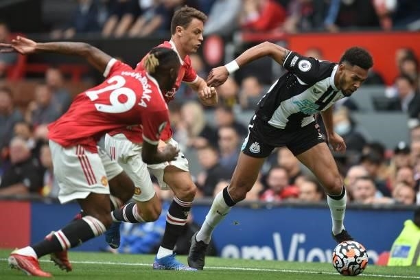Newcastle United's Brazilian striker Joelinton vies with Manchester United's English defender Aaron Wan-Bissaka and Manchester United's Serbian...