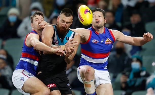 Zaine Cordy of the Bulldogs, Charlie Dixon of the Power and Stefan Martin of the Bulldogs in action during the 2021 AFL Second Preliminary Final...