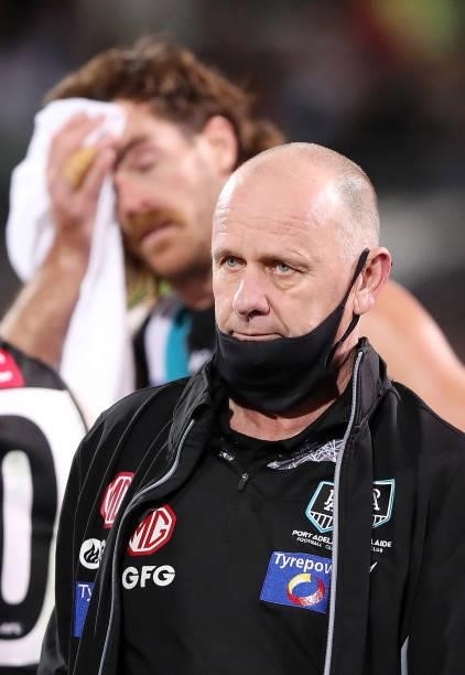 Ken Hinkley, Senior Coach of the Power at quarter time with Scott Lycett in the background during the 2021 AFL Second Preliminary Final match between...