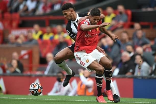 Newcastle United's Brazilian striker Joelinton vies with Manchester United's French defender Raphael Varane during the English Premier League...