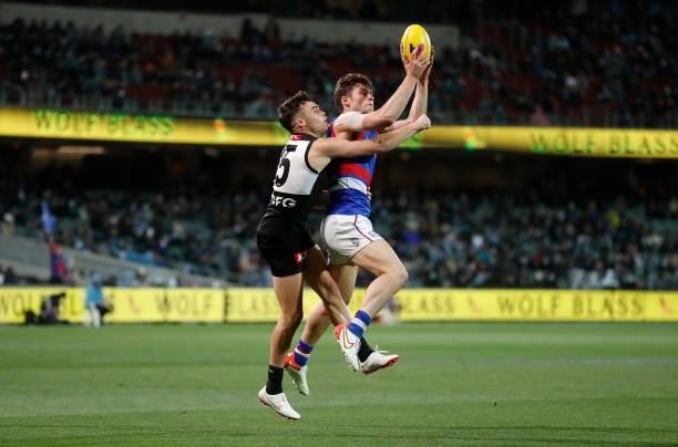 Josh Dunkley of the Bulldogs and Karl Amon of the Power in action during the 2021 AFL Second Preliminary Final match between the Port Adelaide Power...