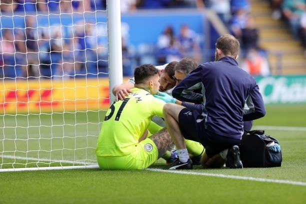 Ederson of Manchester City receives treatment during the Premier League match between Leicester City and Manchester City at King Power Stadium on...