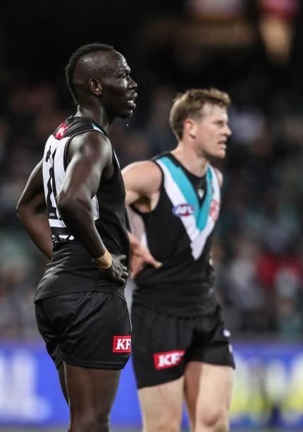 Tom Jonas of the Power and Aliir Aliir put their hands on their hips after another Bulldogs goal goes through during the 2021 AFL Second Preliminary...