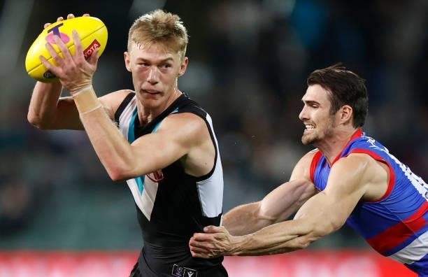 Todd Marshall of the Power is tackled by Easton Wood of the Bulldogs during the 2021 AFL Second Preliminary Final match between the Port Adelaide...