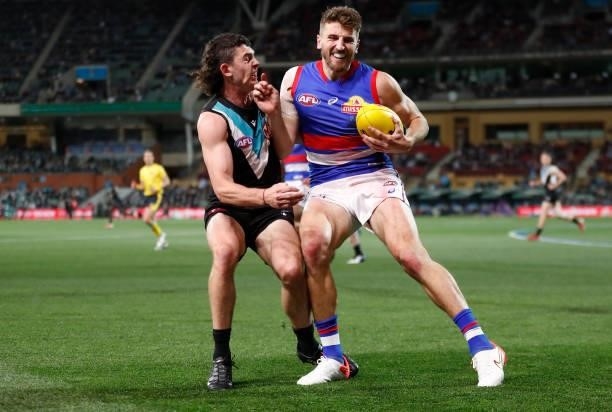 Darcy Byrne-Jones of the Power and Marcus Bontempelli of the Bulldogs in action during the 2021 AFL Second Preliminary Final match between the Port...