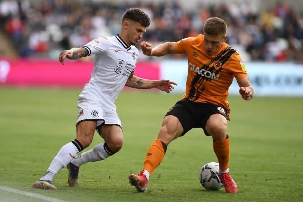 Jamie Paterson of Swansea City battles with Greg Docherty of Hull City during the Sky Bet Championship match between Swansea City and Hull City at...